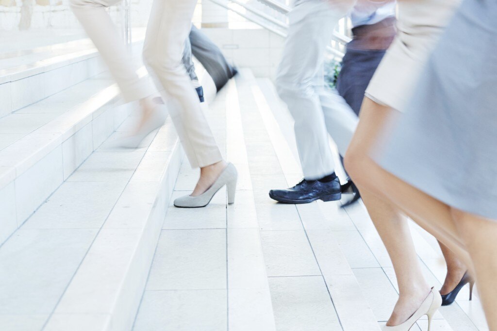 People running up stairs in business attire
