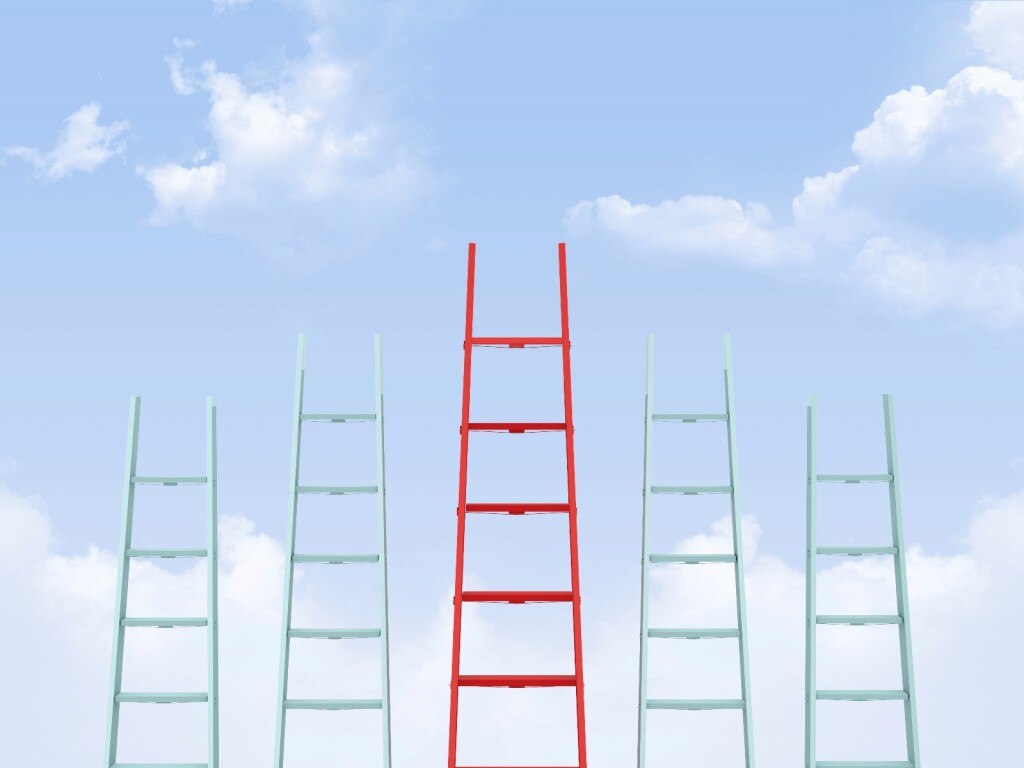 Cinco escaleras con una roja más alta en el medio sobre un fondo del cielo