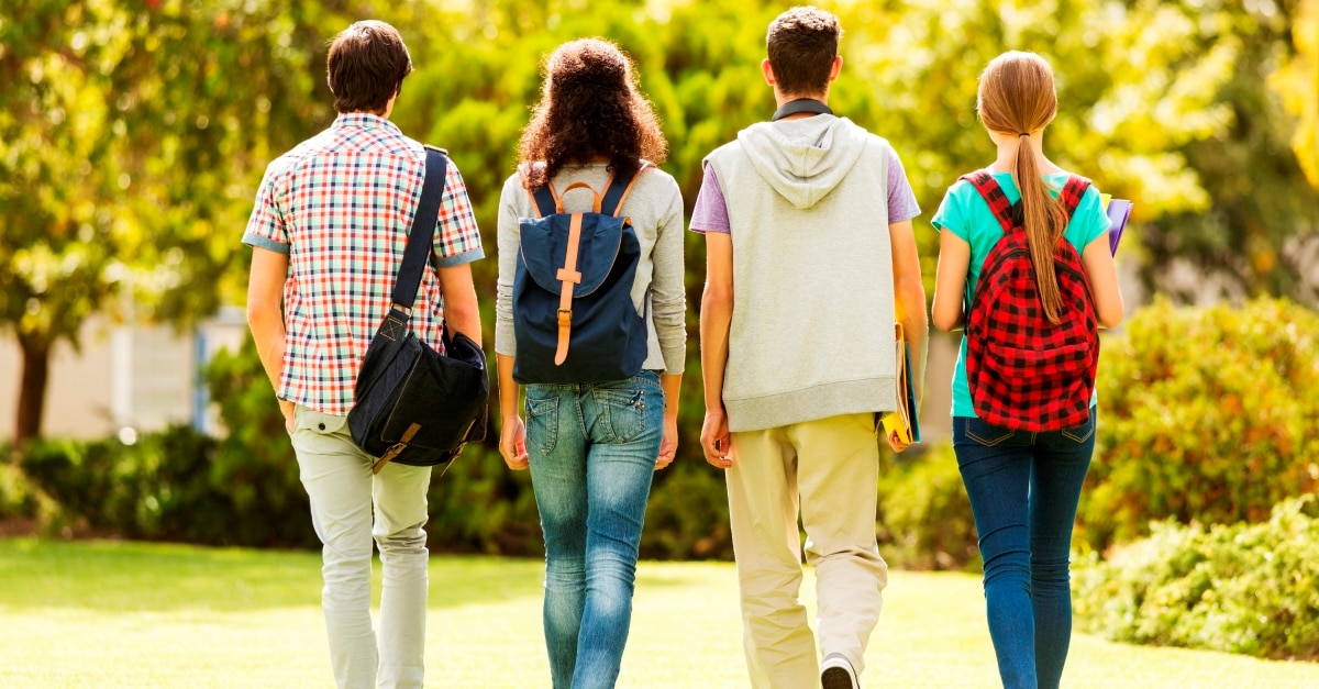 Rear View Of A Group Of Students Walking On Campus