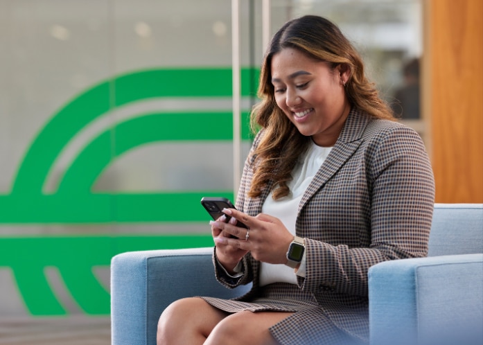 Enterprise Mobility Team Member Sat Down Looking at Social Media on the Phone