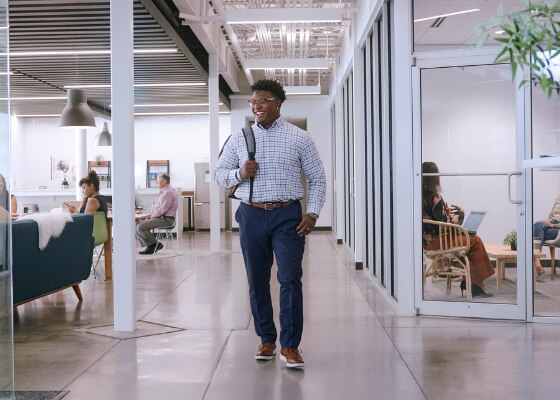 Enterprise Mobility employee in office walking down corridor